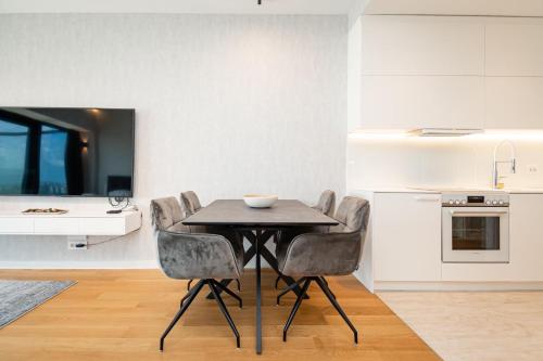 a kitchen and dining room with a table and chairs at West Tower Luxury in Fontana
