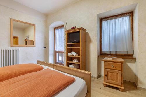 Ένα ή περισσότερα κρεβάτια σε δωμάτιο στο Agriturismo Maso Rocca
