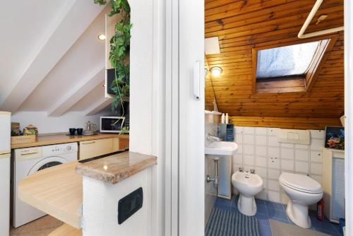 a bathroom with a toilet and a sink at Mansarda Sotto Le Stelle in Savona