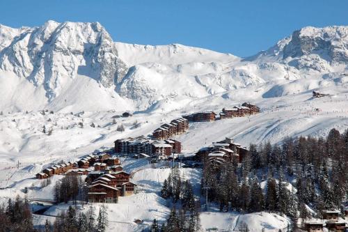 un lodge de ski sur une montagne enneigée avec des montagnes enneigées dans l'établissement La Plagne Appartement 5 couchages Skis aux pieds, à La Plagne Tarentaise