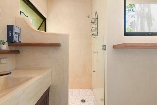 a bathroom with a shower and a sink at 1-BR Gem Apartment Villa Sofia in Chemuyil