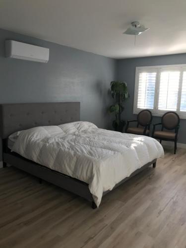 a bedroom with a bed with a white comforter at Room 1 in Fremont