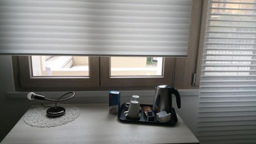 a kitchen counter with a coffee maker and a window at Il Sole e la Luna B&B in Garda in Garda