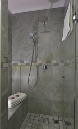 a bathroom with a shower with a glass door at Strandkiewiet in Jacobs Bay
