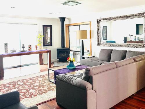 a living room with a couch and a fireplace at Oaklands Junction homes in Konagaderra