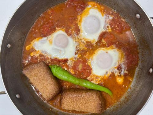 a pan filled with soup with eggs and vegetables at White House-001 in Yeghegnadzor
