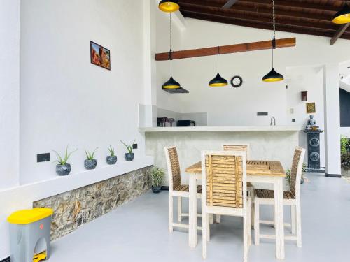a dining room with a table and chairs at Thara Inn Villa in Dickwella