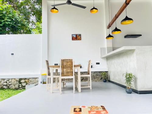 a kitchen and dining room with a table and chairs at Thara Inn Villa in Dickwella
