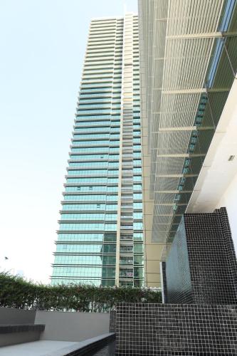 a tall building with a staircase in front of it at Delmon دلمون in Abu Dhabi