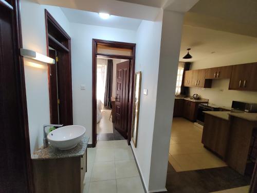 a view of a kitchen with a sink in a room at The Arches Accola in Nairobi