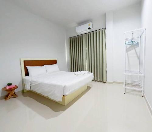 Ban Na PhoにあるNamthip Houseのベッドと窓のある白い寝室
