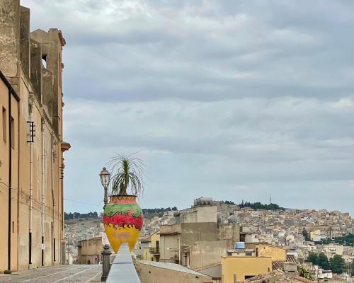 a large vase with a plant in it on a street at ViLoKa Sicilian Guest House in Calatafimi