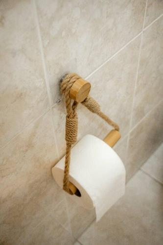 a roll of toilet paper hanging on a wall at Slowing Villas - Villa Âncora in Porto Santo