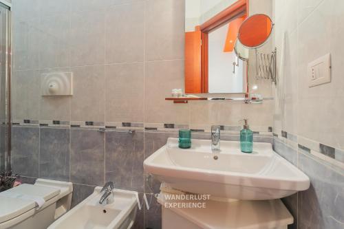 a bathroom with a sink and a toilet at Wanderlust Experience La Casetta in Bitonto