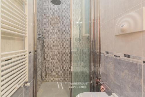 a bathroom with a glass shower with a sink at Wanderlust Experience La Casetta in Bitonto
