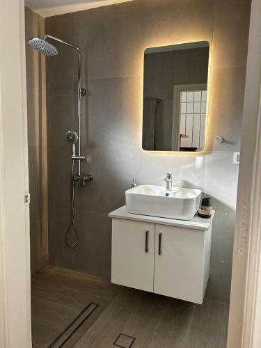 a bathroom with a sink and a mirror at Stelios House in Pserimos in Psérimos