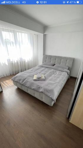 a bedroom with a large bed with two plates on it at Home sweet home in Chişinău