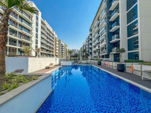 a large swimming pool in the middle of a building at Royalton - Serene Studio Apt in the Heart of Meydan District in Dubai