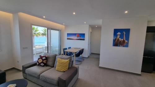 a living room with a couch and a table at Costa Luz Beach Apartments in Puerto del Carmen