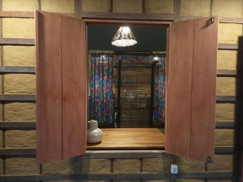 a wooden cabinet with a vase sitting inside of it at Chalé Dona Ramira in Alter do Chao