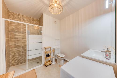 a white bathroom with a toilet and a sink at Cosy Melun 25 min Gare de Lyon in Melun
