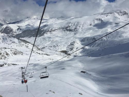 a ski lift going up a snow covered mountain at Apartamentos SNÖ Edelweiss in Cerler