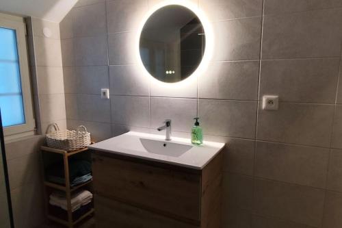 a bathroom with a sink and a mirror on the wall at Belle petite maison de 70m2 in Neuwiller-lès-Saverne