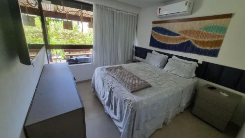 En eller flere senge i et værelse på Apartamento terreo no reserva dos Carneiros