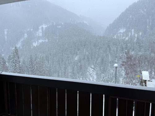 a view of a snow covered mountain from a balcony at Ferienwohnung Rendl-Blick in Sankt Anton am Arlberg
