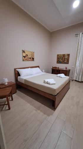 a bedroom with a large bed and a table at Casa Vacanze Enrica House in Naples