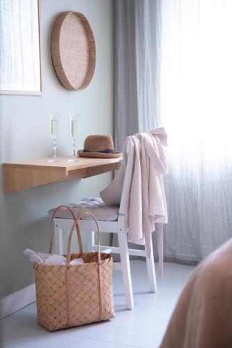 a room with a table and a chair with a basket at Kallehavegaard Badehotel in Løkken