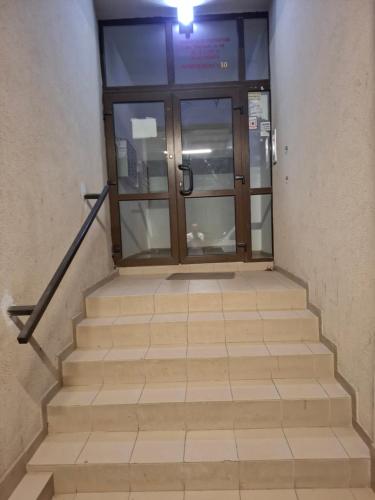 an entrance to a building with a glass door and stairs at Casa Grazia in Balta Albă