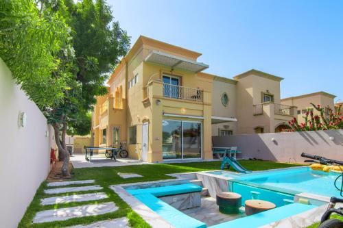 a house with a swimming pool in a yard at Elegant lakeside villa with a private pool in Dubai