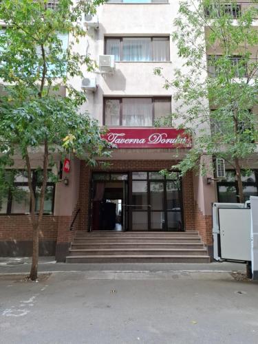 a building with a red sign on the front of it at Casa Grazia in Balta Albă