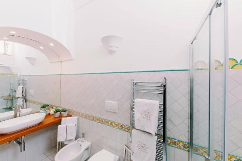 a bathroom with a sink and a mirror at Villa Mary Suites in Positano
