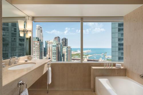 a bathroom with a tub and a large window at Swissotel Chicago in Chicago
