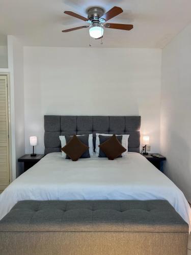 a bedroom with a large bed with a ceiling fan at VILLAS EL ENCANTO in Jalpan