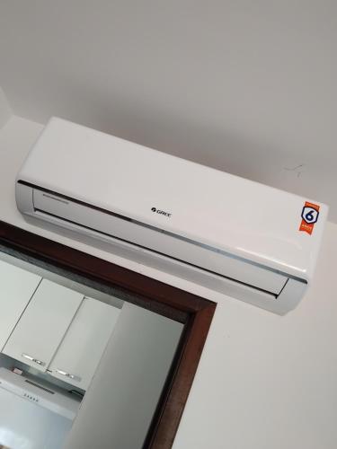 a white router sitting on top of a shelf at Flat Litoral Sul da Paraíba- Praia Carabibus in Conde