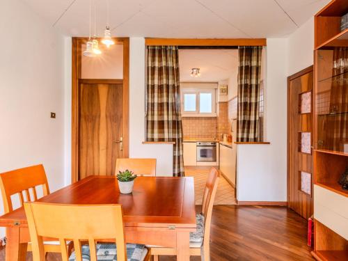 a kitchen and dining room with a wooden table and chairs at Apartment SunnyLake by Interhome in Riva del Garda