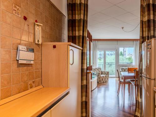 a kitchen with a refrigerator and a dining room at Apartment SunnyLake by Interhome in Riva del Garda
