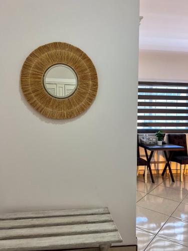 a mirror on a white wall with a table at VILLAS EL ENCANTO in Jalpan