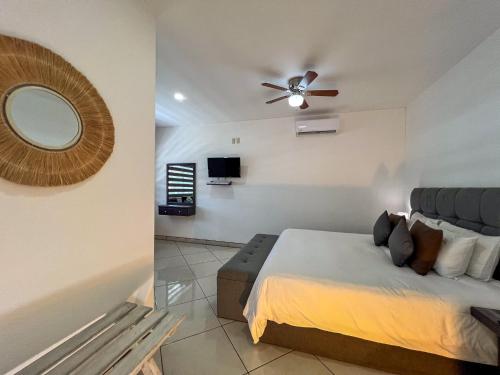 a bedroom with a bed and a ceiling fan at VILLAS EL ENCANTO in Jalpan