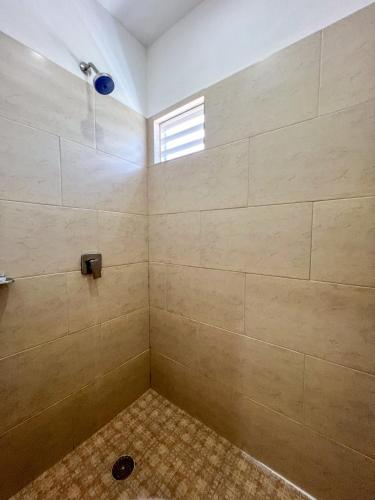 a bathroom with a shower with a shower head at VILLAS EL ENCANTO in Jalpan