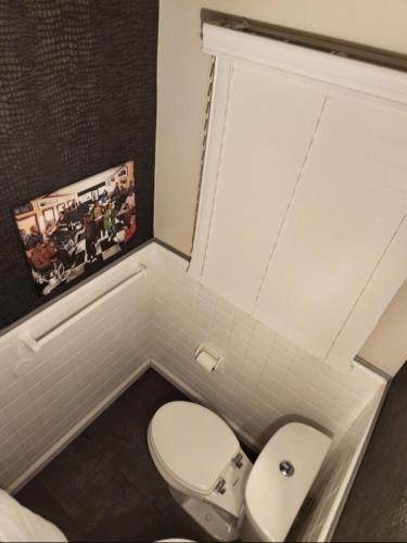 a bathroom with a white toilet and a sink at Amazing DC Home Away From Home in Washington, D.C.