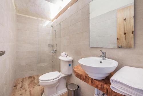 a bathroom with a white toilet and a sink at Majestic villa with stunning views in Jarabacoa in Buena Vista