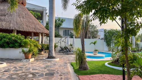 a resort with a swimming pool and palm trees at VILLAS EL ENCANTO in Jalpan