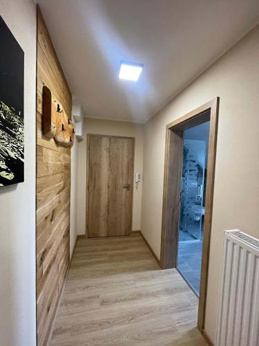 a hallway with a door leading into a room at Apartmány U Bernharda in Vítkov