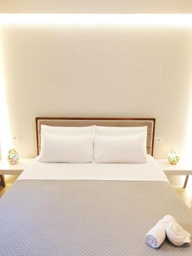 a bed with a pair of slippers sitting on it at Panorama Suite in Piazza Armerina