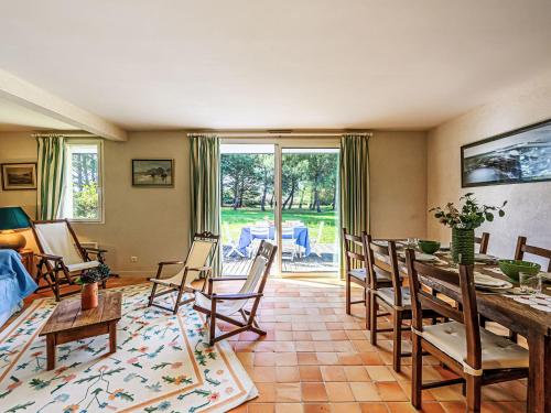 a living room with a dining room table and chairs at Holiday Home Le Prado-2 by Interhome in Saint-Philibert
