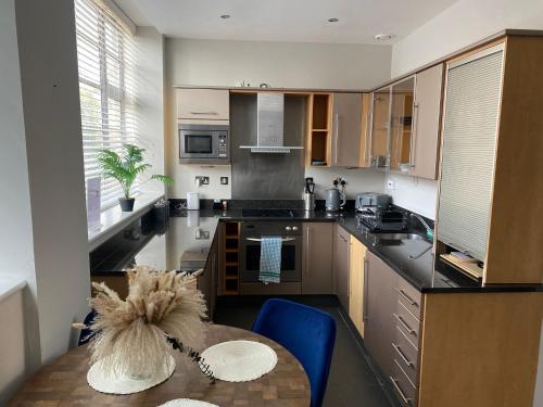 a kitchen with a table and a counter top at Your Holiday & Home Brighton in Brighton & Hove